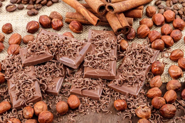 Chocolate Tiles Cinnamon Nuts Wooden Background — Stock Photo, Image