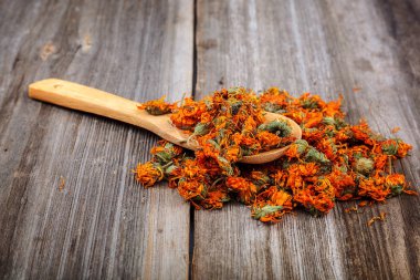 Ahşap arka planda kurumuş takvim çiçekleri. İlaç bitkileri.