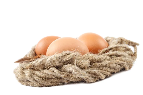 Куриные яйца на холсте на белом фоне — стоковое фото