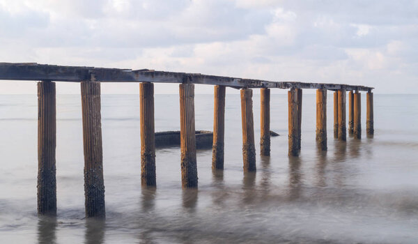 Old Bridge During Sunrise at tropical sea, Thailand