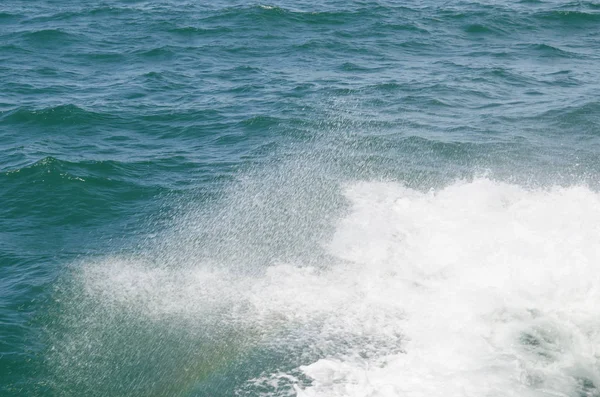 Boat wake on the water near the boat