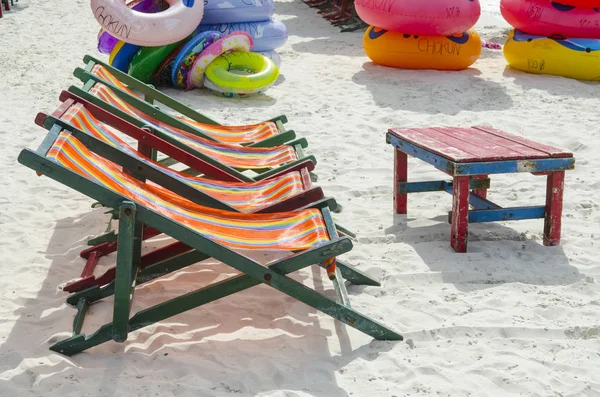empty beach chairs on sand