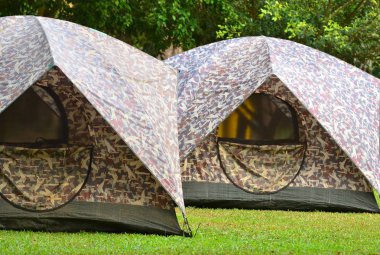 Campsite tents on filed for travel background 