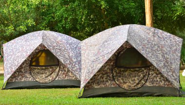 Campsite tents on filed for travel background 