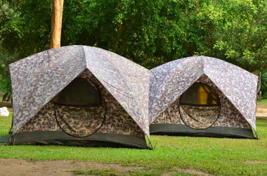 Campsite tents on filed for travel background 