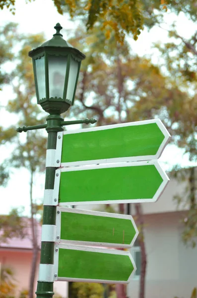 four street signs on street lamp