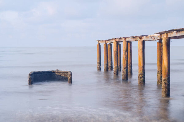 Bridge on beach in sunrise and sea wave in Rayong, Thailand