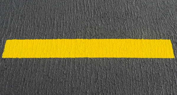 A picture of black and yellow airport markings on concrete