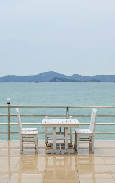 Dining table on a beach close to the ocean