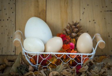 easter still life in a basket on a wooden background