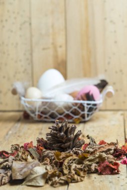 Paskalya yumurtaları tahta arka plan ile sepet içinde