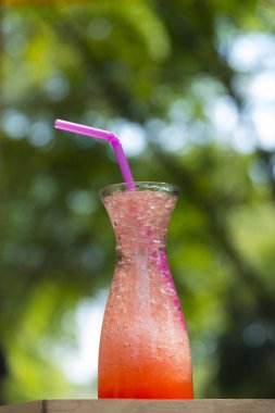 Strawberry Drinking water with a straw