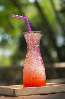 Strawberry Drinking water with a straw