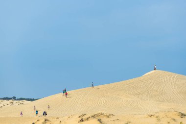 Mui ne city, Vietnam - JANUARY 18: Unidentified tourist alone on the sand dune in morning on January 18,2016 at White sand dune, Mui ne, Vietnam