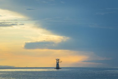 beautiful view of sunset with sea and lighthouse, Thailand 