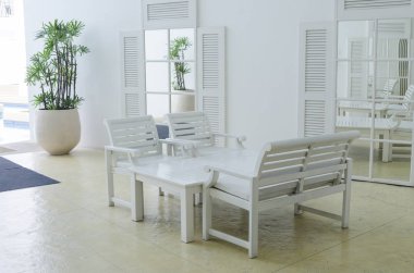 Table and chairs in white room