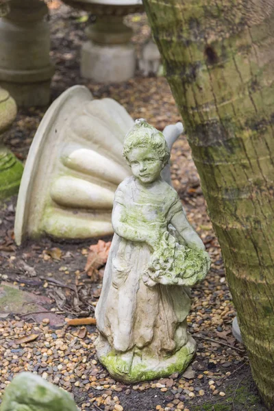 ancient cupid statue in garden