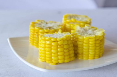 delicious cooked corn on white plate