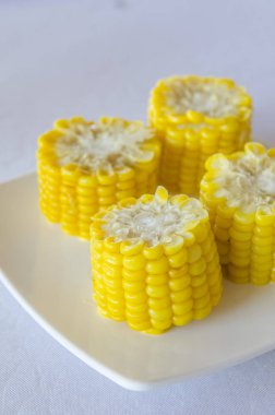 delicious cooked corn on white plate
