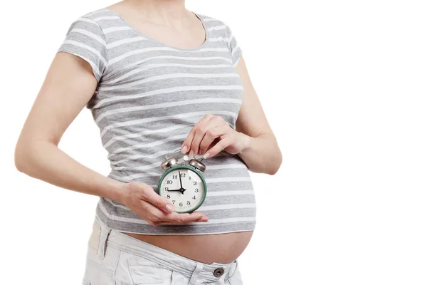 Zwangere Vrouw Met Een Klok Hand Geïsoleerd — Stockfoto