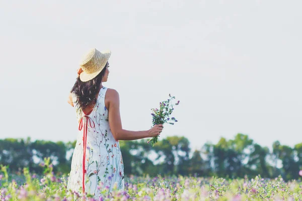 Yonca, yumuşak odak arka plan alanında güzel genç kadın