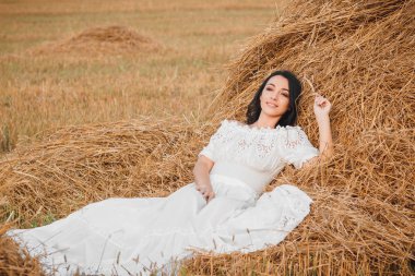 Kurutulmuş samanlık, yumuşak odak arka plan üzerinde güzel genç kadın
