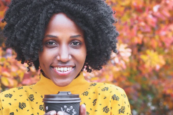 Portrait: Young dark-skinned woman dressed in casual clothes, autumn