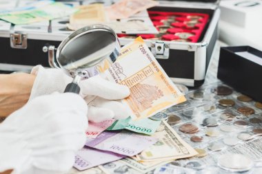 Elinde beyaz eldiven, farklı Amerikan Doları ve Hint JT, nümismatik kavramı