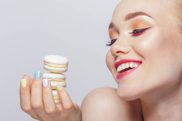 Portrait of beautiful woman with macarons