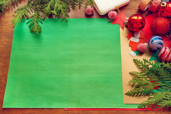 preparation for Christmas. The child makes a paper card, packaging gifts.