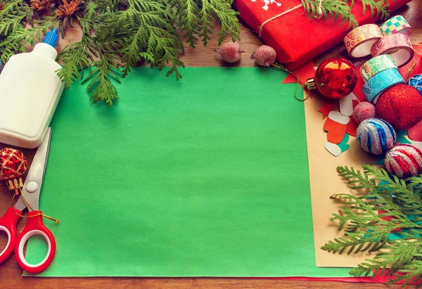 preparation for Christmas. The child makes a paper card, packaging gifts.