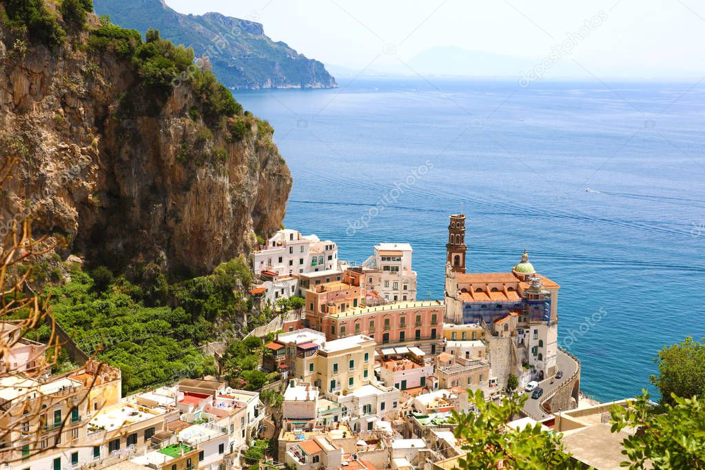 Beautiful aerial view of Atrani village between green branches and cliff rocks, Amalfi Coast, Italy