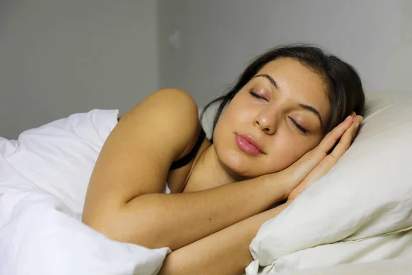 Young woman sleeping in bed at night. Sleeping time.