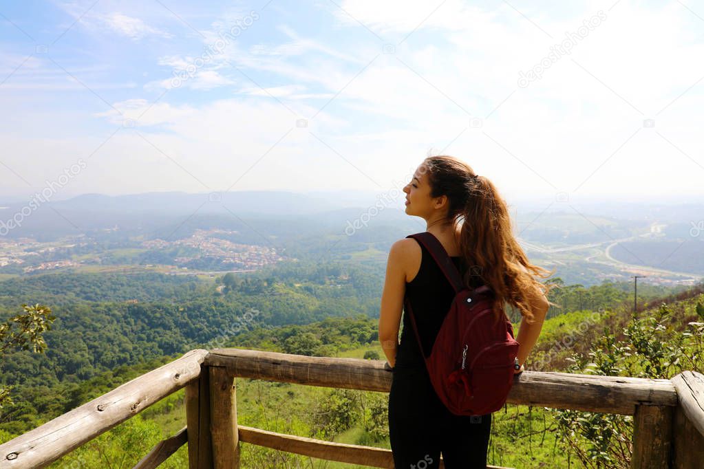 Hiker with backpack enjoying view from Jaragua Peak, Sao Paulo, Brazil
