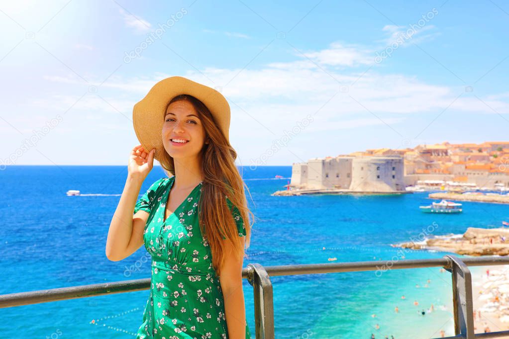 Happy beautiful woman enjoying her cruise in Mediterranean Sea. Smiling traveler girl enjoying her summer holidays in Dubrovnik, Croatia, Europe.