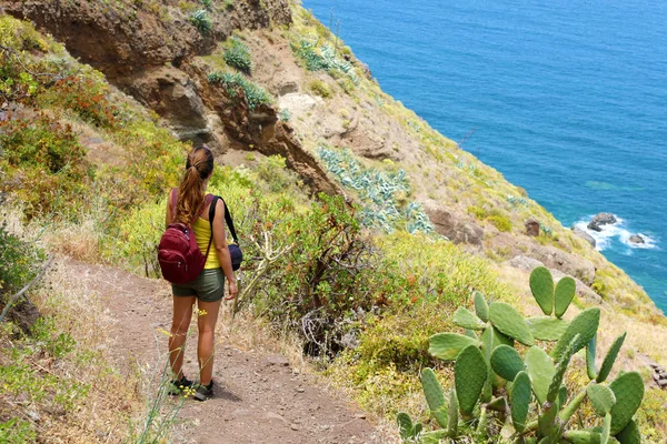 Traveler hiker woman enjoying landscape in Tenerife, Spain. Natural tourism backpacker trekking adventure concept.