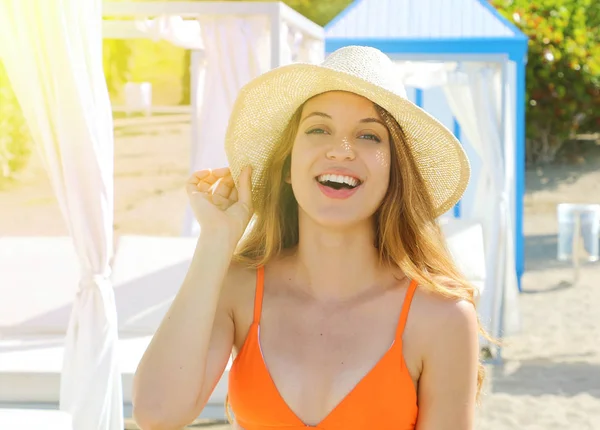 Beautiful cheerful young bikini woman enjoying holidays summer sunlight on resort hotel on the beach in Tenerife, Spain.
