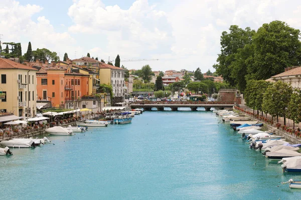 PESCHIERA DEL GARDA - 9 Haziran 2020: İtalya Garda Gölü 'ndeki su kanalı boyunca gezinti ve eğlence yapan güzel tarihi şehir merkezi