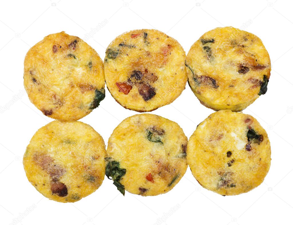 Egg muffins with spinach, bacon, cheese and tomatoes isolated on white