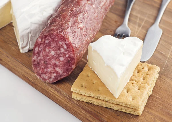 Snack with Brie Cheese And Salami On A Wooden Board — Stock Photo, Image