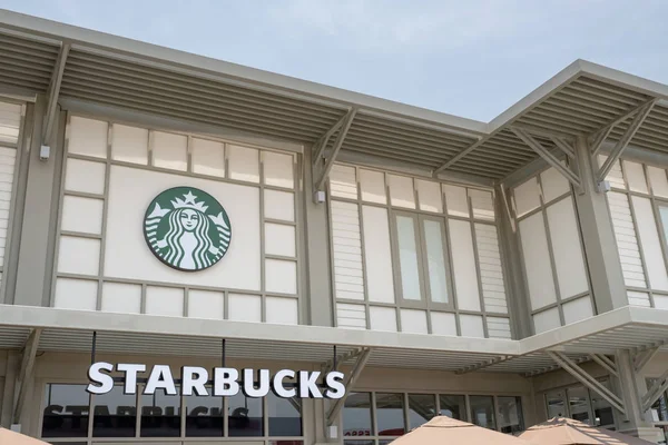 16 April 2019: Starbucks Coffee and logo sign on wall, hanging o — Stock Photo, Image