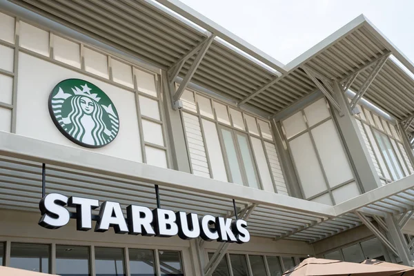 16 April 2019: Starbucks Coffee and logo sign on wall, hanging o — Stock Photo, Image
