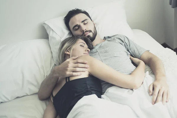 Loving happy couple in love smile and hug each other on the bed, — Stock Photo, Image