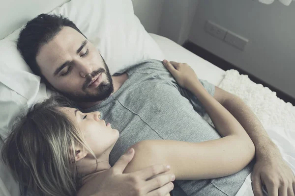 Loving happy couple in love smile and hug each other on the bed, — Stock Photo, Image