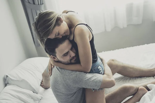 Loving happy couple in love smile and hug each other on the bed, — Stock Photo, Image