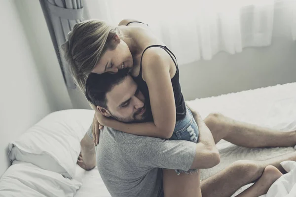 Loving happy couple in love smile and hug each other on the bed, — Stok Foto