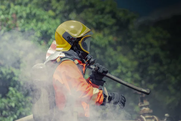 Bombero vistiendo suite de seguridad y caminando a la zona de daños por fuego — Foto de Stock