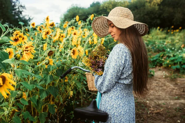 Ayçiçekleri arasında tarlada yürüyün