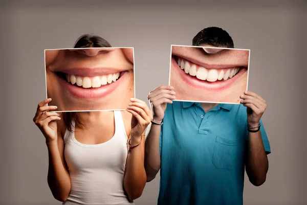Szczęśliwa Para Trzymając Obraz Usta Uśmiechający Się Szarym Tle — Zdjęcie stockowe