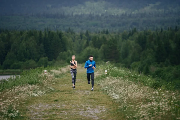 Trainer and female sportsman jogging outdoor